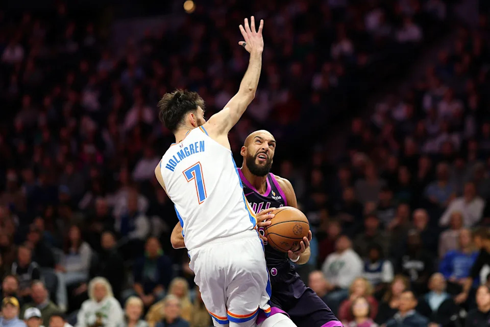 MINNEAPOLIS, MINNESOTA - DECEMBER 19: Rudy Gobert #27 of the Minnesota Timberwolves draws a foul against Chet Holmgren #7 of the Oklahoma City Thunder in the second quarter at Target Center on December 19, 2025 in Minneapolis, Minnesota. NOTE TO USER: User expressly acknowledges and agrees that, by downloading and or using this photograph, User is consenting to the terms and conditions of the Getty Images License Agreement. (Photo by David Berding/Getty Images)