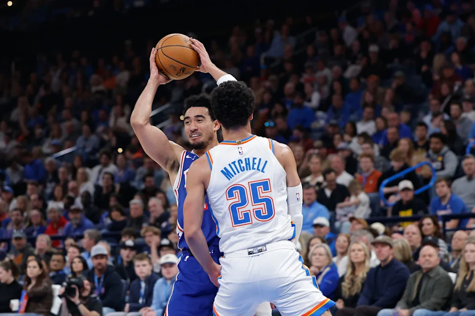 Dec 28, 2025; Oklahoma City, Oklahoma, USA; Philadelphia 76ers guard Jared McCain (20) passes as Oklahoma City Thunder guard Ajay Mitchell (25) defends during the second quarter at Paycom Center. Mandatory Credit: Alonzo Adams-Imagn Images