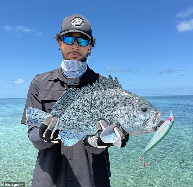 Simmons shows what appears to be a grouper. The Australian is now a competitive fisherman