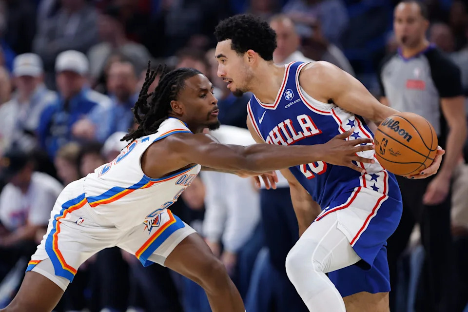 Dec 28, 2025; Oklahoma City, Oklahoma, USA; Oklahoma City Thunder guard Cason Wallace (22) reaches to steal the ball away from Philadelphia 76ers guard Jared McCain (20) during the second half at Paycom Center. Mandatory Credit: Alonzo Adams-Imagn Images