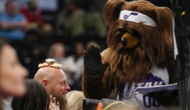 Utah Jazz Bear places pastries on a fan’s head
