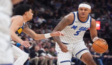 Orlando Magic forward Paolo Banchero, right, drives past Denver Nuggets guard Julian Strawther in the first half of an NBA basketball game, Thursday, Dec. 18, 2025, in Denver. (AP Photo/David Zalubowski)