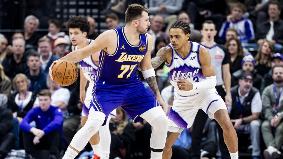 Los Angeles Lakers guard Luka Dončić (77) backs down Utah Jazz guard Keyonte George (3)...