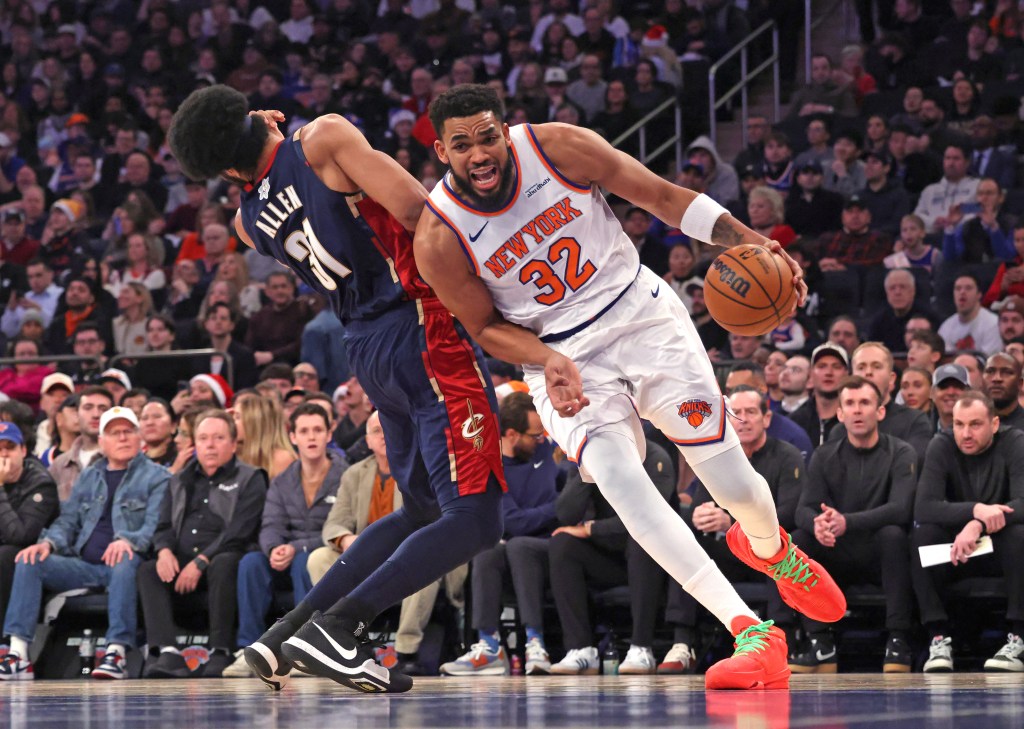  New York Knicks center Karl-Anthony Towns #32 is called for an offensive foul as he drives into Cleveland Cavaliers center Jarrett Allen #31 during the first quarter.