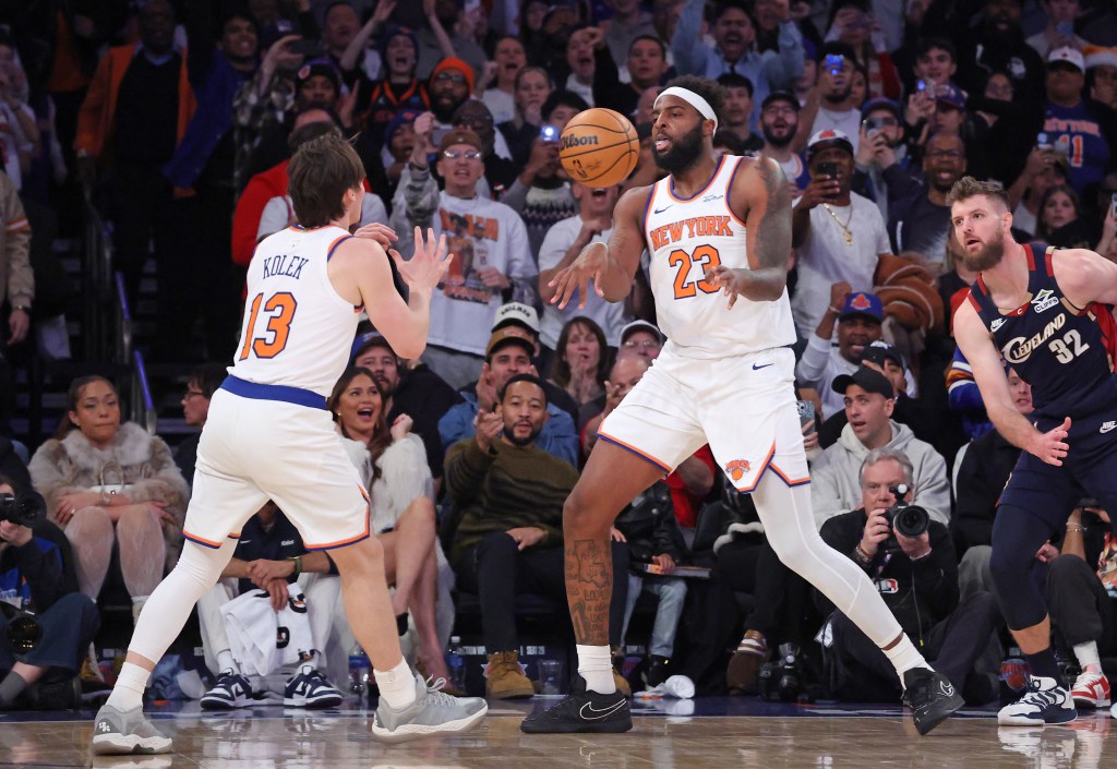 Mitchell Robinson #23 passes the ball to New York Knicks guard Tyler Kolek #13 during the fourth quarter.