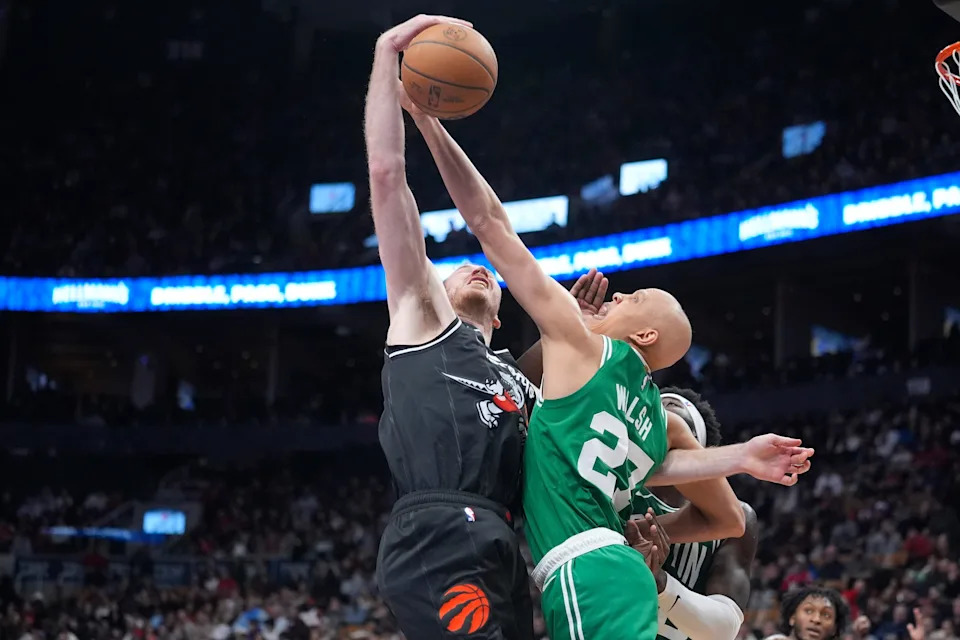 Dec 7, 2025; Toronto, Ontario, CAN; Boston Celtics forward Jordan Walsh (27) defends against Toronto Raptors center Jakob Poeltl (19) during the second half at Scotiabank Arena. Mandatory Credit: John E. Sokolowski-Imagn Images