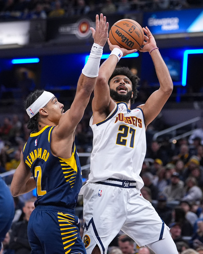 Denver Nuggets guard Jamal Murray (27) shoots over Indiana Pacers guard Andrew Nembhard (2) during the second half of an NBA basketball game in Indianapolis, Wednesday, Dec. 3, 2025. (AP Photo/Michael Conroy)