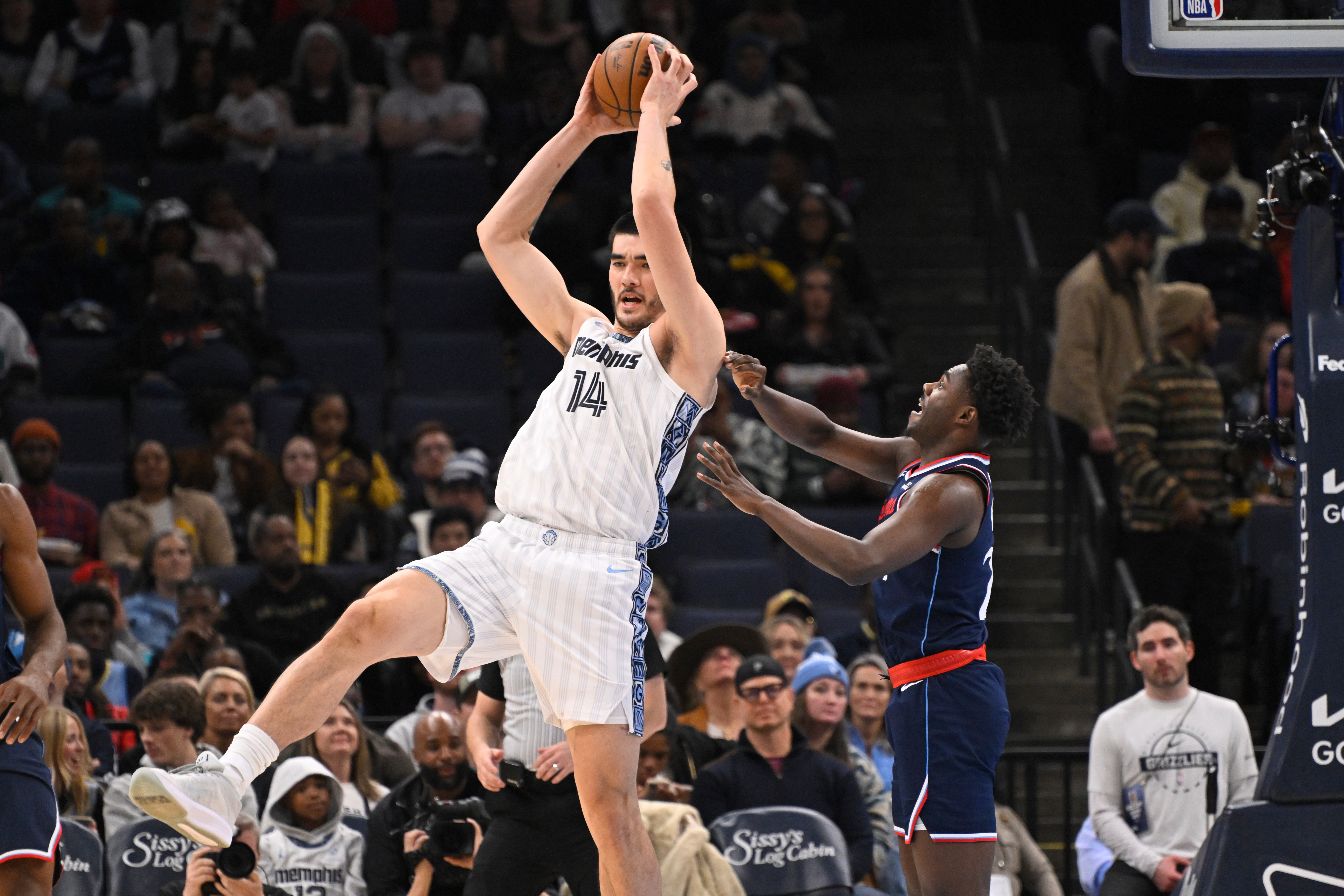 Memphis Grizzlies center Zach Edey grabs a high pass as...