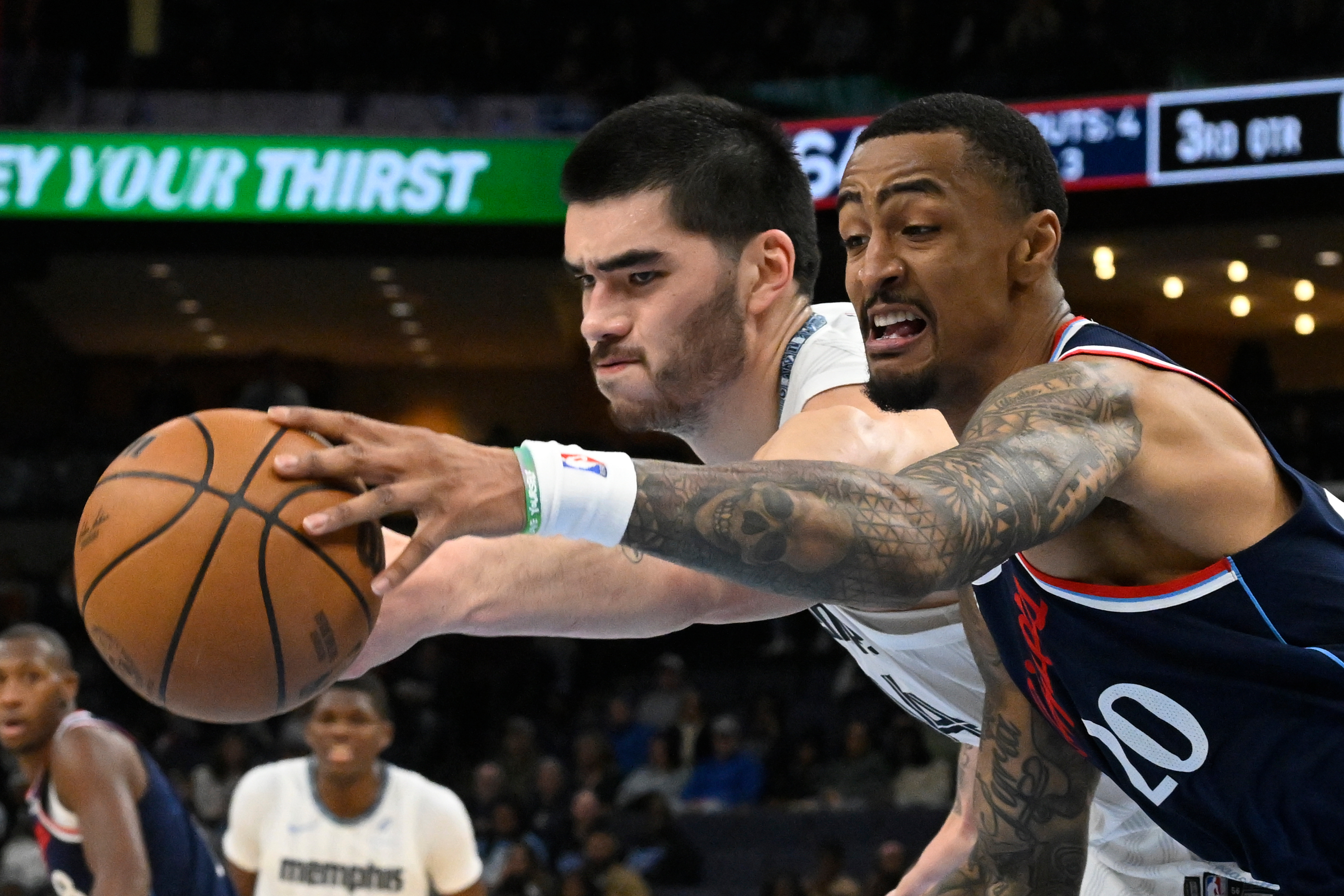Clippers forward John Collins, right, and Memphis Grizzlies center Zach...