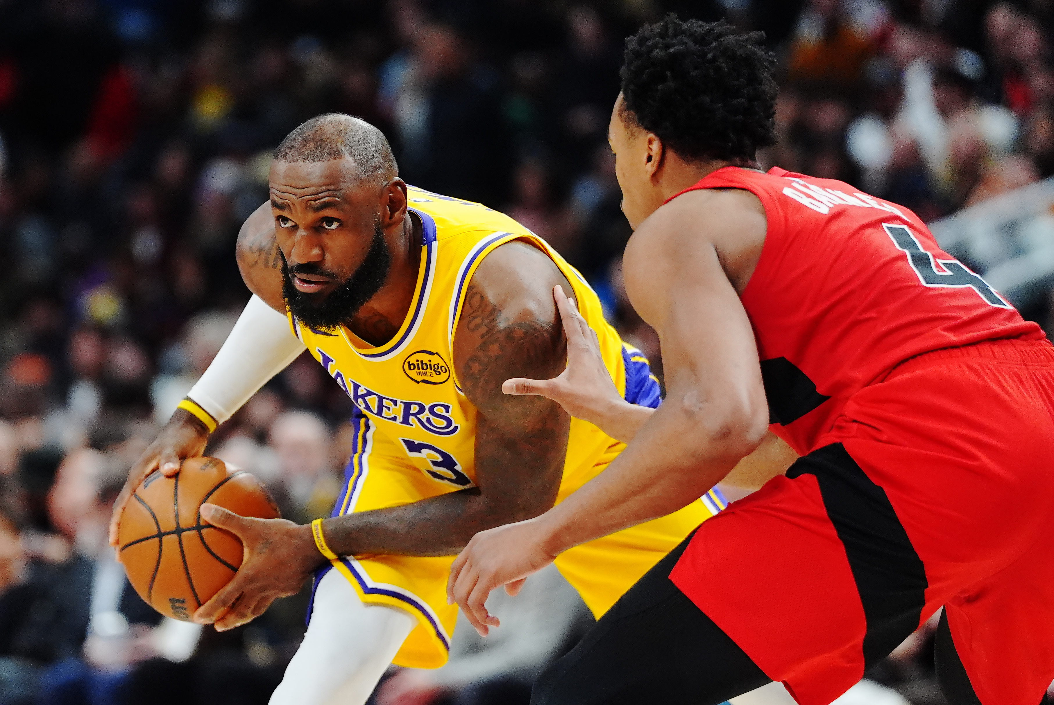 Lakers star LeBron James, left, handles the ball as the...