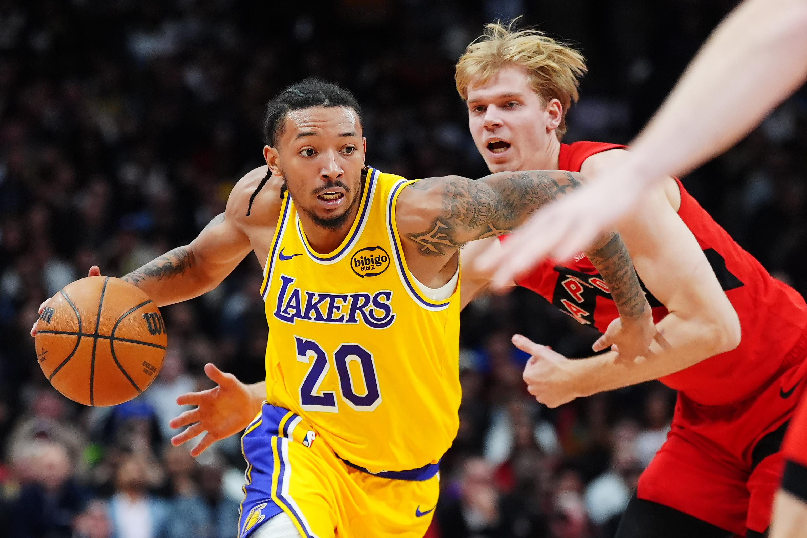 Lakers guard Nick Smith Jr. drives past the Toronto Raptors’...
