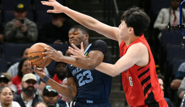 Memphis Grizzlies forward Cedric Coward (23) handles the ball against Portland Trail Blazers center Yang Hansen (16) in the first half of an NBA basketball game Sunday, Dec. 7, 2025, in Memphis, Tenn. (AP Photo/Brandon Dill)