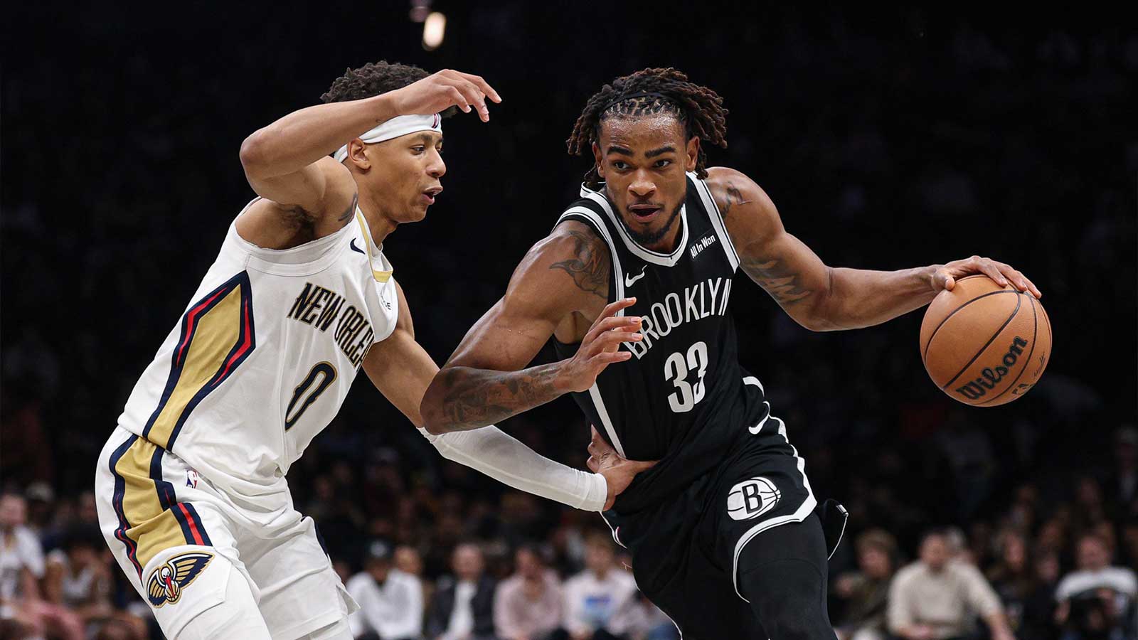 Brooklyn Nets center Nic Claxton (33) dribbles asNew Orleans Pelicans as New Orleans Pelicans guard Jeremiah Fears (0) defends during the second half at Barclays Center.