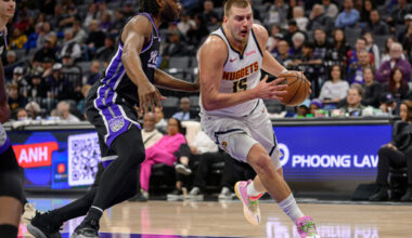 Denver Nuggets center Nikola Jokic (15) drives past Sacramento Kings forward Precious Achiuwa during the first half of an NBA basketball game in Sacramento, Calif., Thursday, Dec. 11, 2025. (AP Photo/Randall Benton)