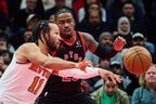 New York Knicks' Jalen Brunson (11) lines up a pass past Toronto Raptors' Jamal Shead (23) during their game on Tuesday. Sammy Kogan/The Canadian Press