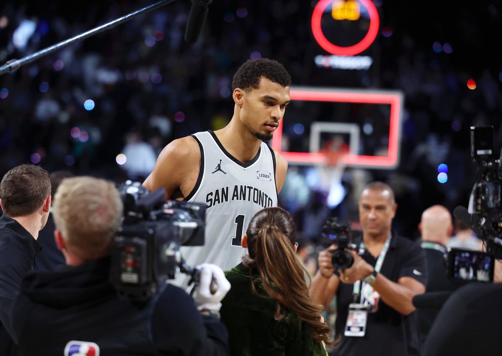San Antonio Spurs forward Victor Wembanyama (1) stands on court before film crews after playing in an NBA Cup semifinals basketball game against the Oklahoma City Thunder, Saturday, Dec. 13, 2025, in Las Vegas. (AP Photo/Ronda Churchill)
