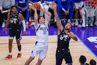 Dallas Mavericks forward Cooper Flagg (32) drives to the basket guarded by Utah Jazz forward...