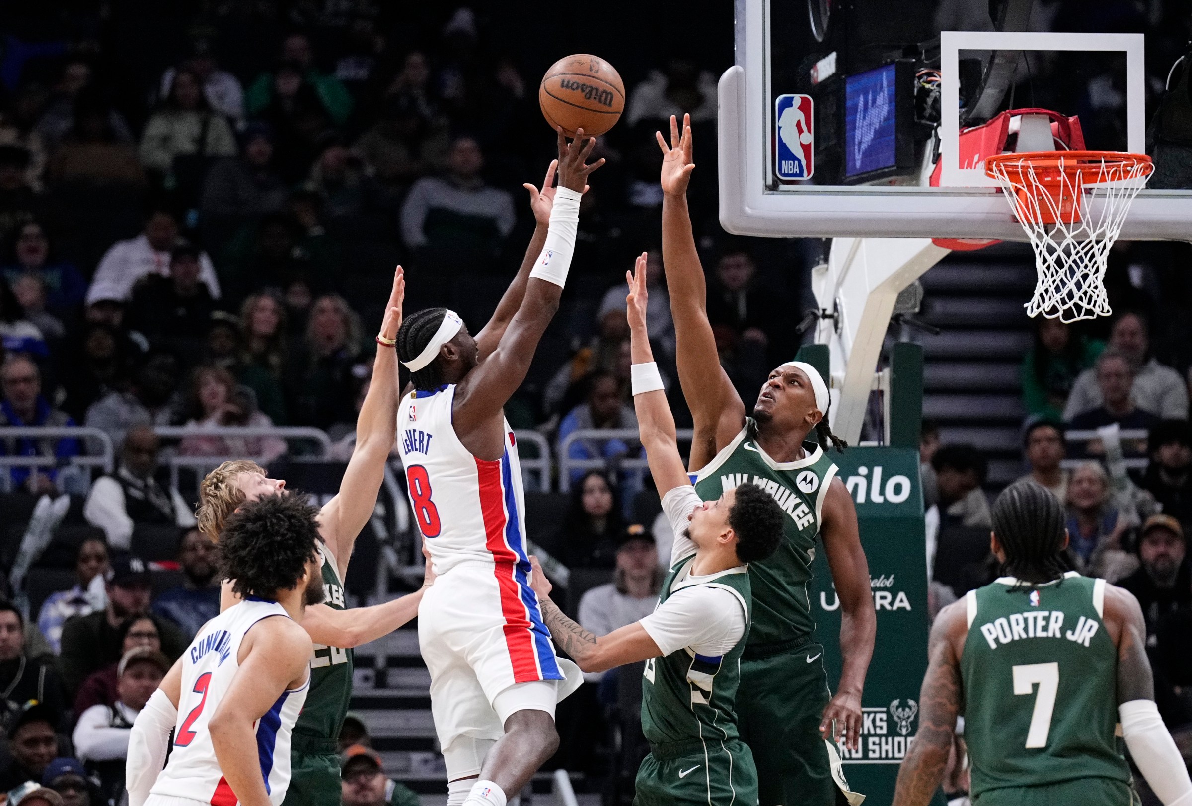 Dec 3, 2025; Milwaukee, Wisconsin, USA; Detroit Pistons guard Caris LeVert (8) is surrounded by guard AJ Green (20), Milwaukee Bucks guard Ryan Rollins (13) and center Myles Turner (3) in the second half at Fiserv Forum. Mandatory Credit: Michael McLoone-Imagn Images