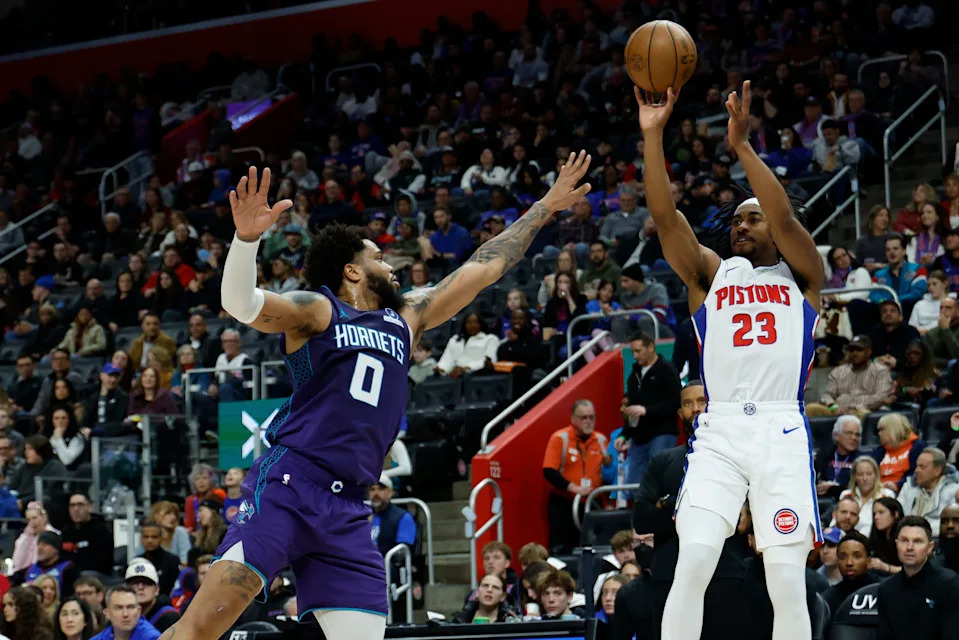 Detroit Pistons guard Jaden Ivey (23) shoots over Charlotte Hornets forward Miles Bridges (0) in the first half at Little Caesars Arena in Detroit on Saturday, Dec. 20, 2025.