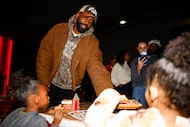 Dallas Mavericks guard Kyrie Irving passes out cookies during the Dallas Mavericks Cookies...