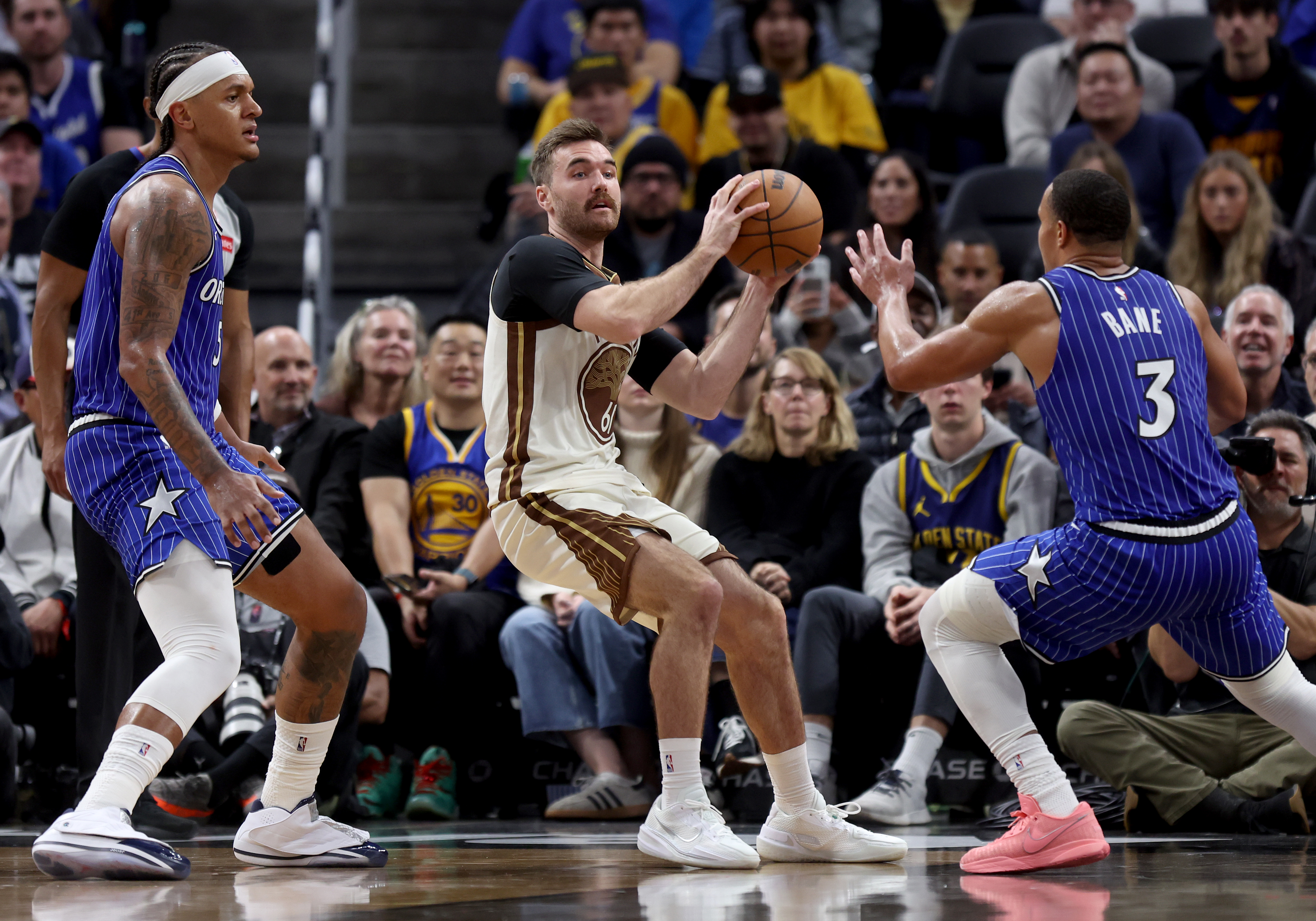 Golden State Warriors' Pat Spencer #61 looks to pass as...