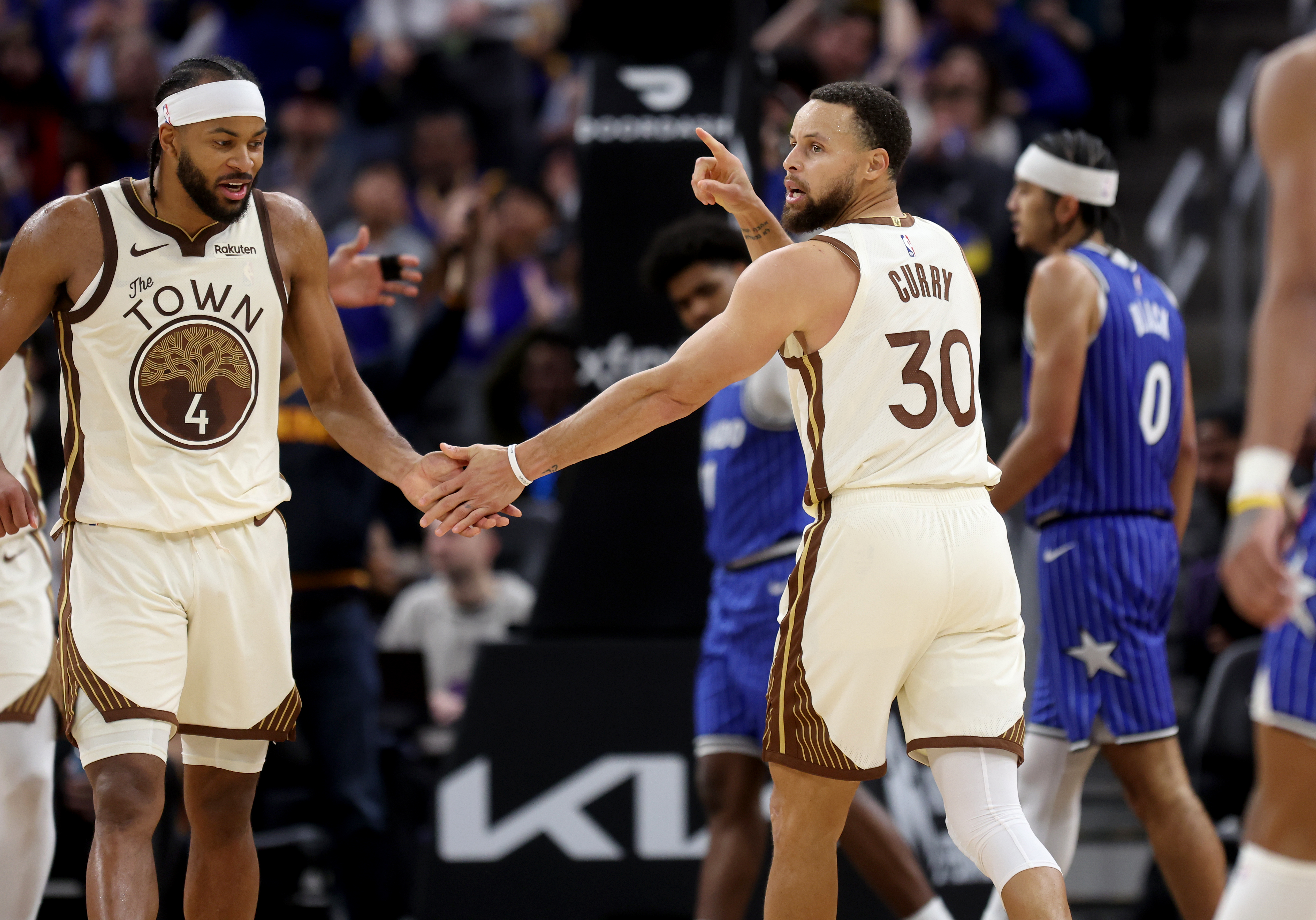 Golden State Warriors' Stephen Curry #30 celebrates with teammate Moses...