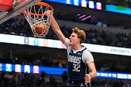 Dallas Mavericks forward Cooper Flagg (32) dunks in the first half of an NBA basketball game...