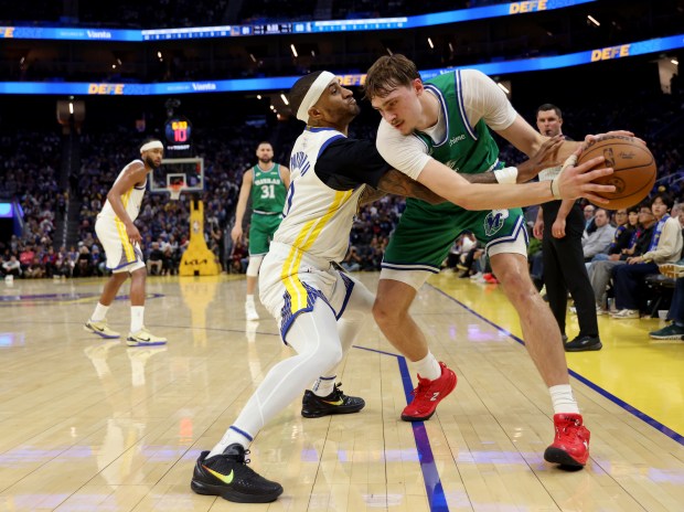 Golden State Warriors' Gary Payton II #0 guards Dallas Mavericks' Cooper Flagg #32 in the third quarter of their Christmas Day NBA game at the Chase Center in San Francisco, Calif., on Thursday, Dec. 25, 2025. (Jane Tyska/Bay Area News Group)