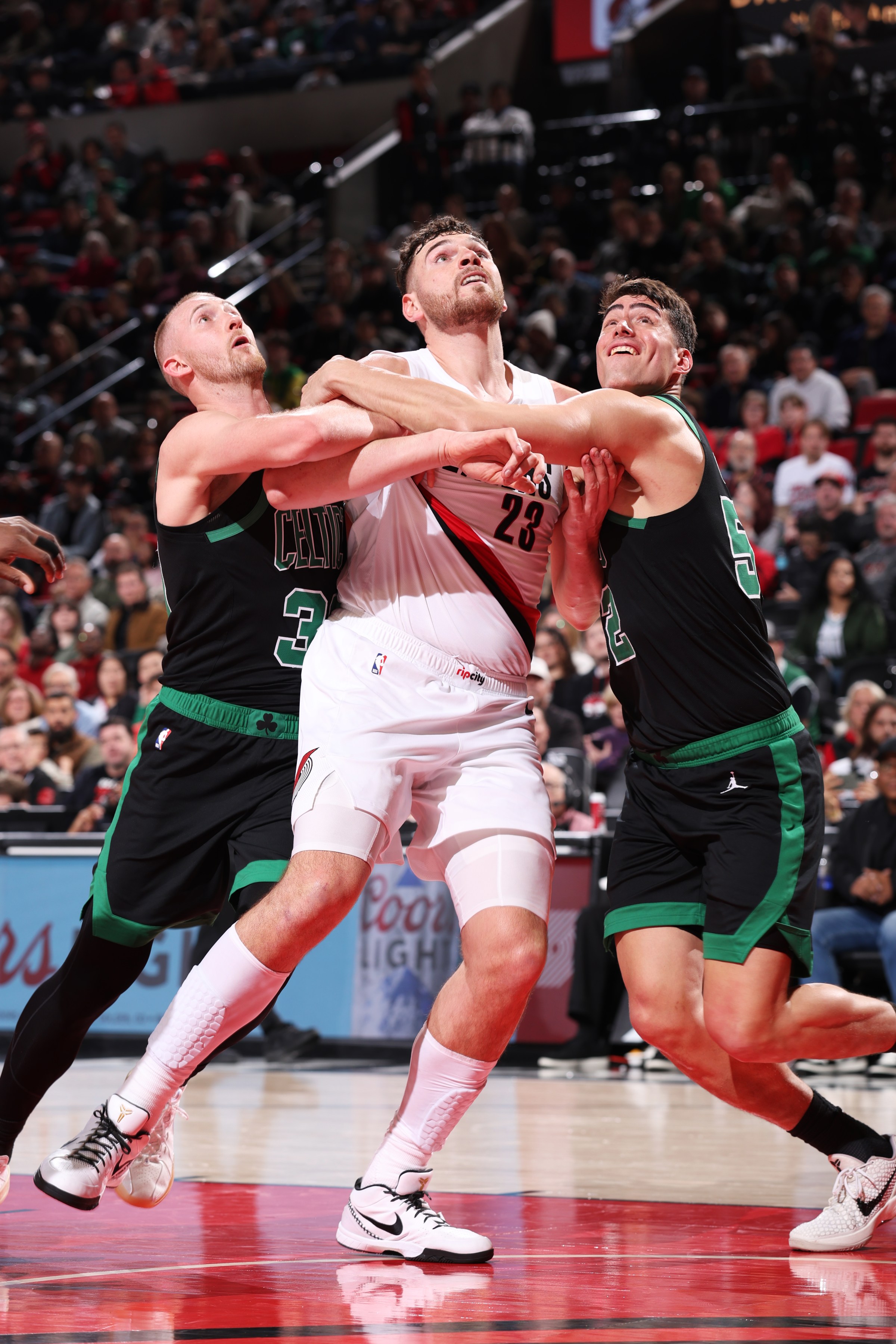 PORTLAND, OR - DECEMBER 28: Sam Hauser #30 and Luka Garza #52 of the Boston Celtics play defense against Donovan Clingan #23 of the Portland Trail Blazers on December 28, 2025 at the Moda Center Arena in Portland, Oregon. NOTE TO USER: User expressly acknowledges and agrees that, by downloading and or using this photograph, user is consenting to the terms and conditions of the Getty Images License Agreement. Mandatory Copyright Notice: Copyright 2025 NBAE (Photo by Jaden Coleman/NBAE via Getty Images)