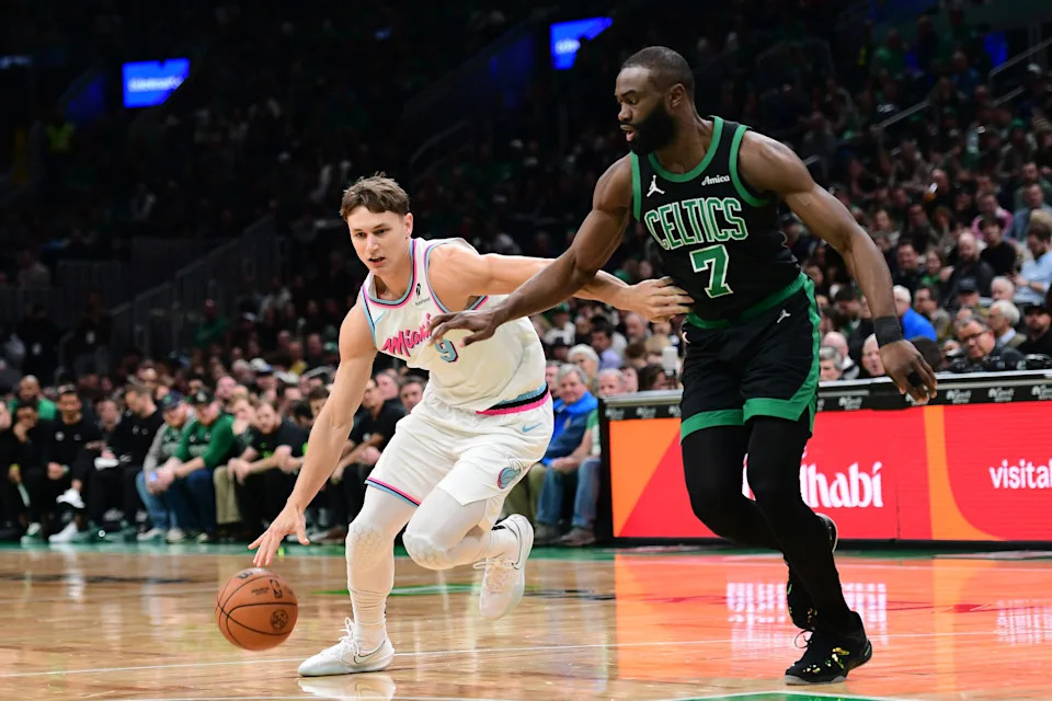 Apr 2, 2025; Boston, Massachusetts, USA; Miami Heat guard Pelle Larsson (9) dribbles against Boston Celtics guard Jaylen Brown (7) during the first half at TD Garden. Mandatory Credit: Bob DeChiara-Imagn Images