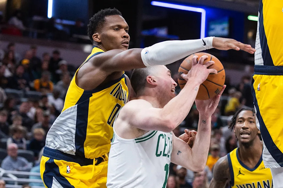 Dec 26, 2025; Indianapolis, Indiana, USA; Boston Celtics guard Payton Pritchard (11) shoots the ball while Indiana Pacers guard/forward Bennedict Mathurin (00) defends in the second half at Gainbridge Fieldhouse. Mandatory Credit: Trevor Ruszkowski-Imagn Images