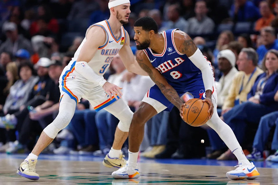 Dec 28, 2025; Oklahoma City, Oklahoma, USA; Philadelphia 76ers forward Paul George (8) moves the ball as Oklahoma City Thunder guard Alex Caruso (9) defends during the second half at Paycom Center. Mandatory Credit: Alonzo Adams-Imagn Images