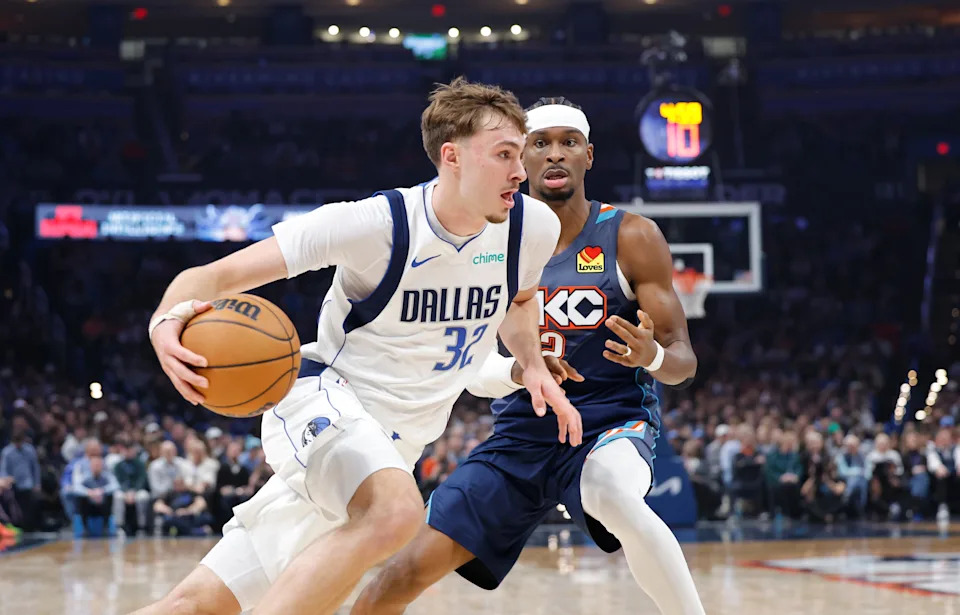 Dec 5, 2025; Oklahoma City, Oklahoma, USA; Dallas Mavericks forward Cooper Flagg (32) drives to the basket around Oklahoma City Thunder guard Shai Gilgeous-Alexander (2) during the second quarter at Paycom Center. Mandatory Credit: Alonzo Adams-Imagn Images