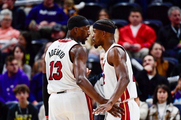 Jimmy Butler and Bam Adebayo talk on the court.