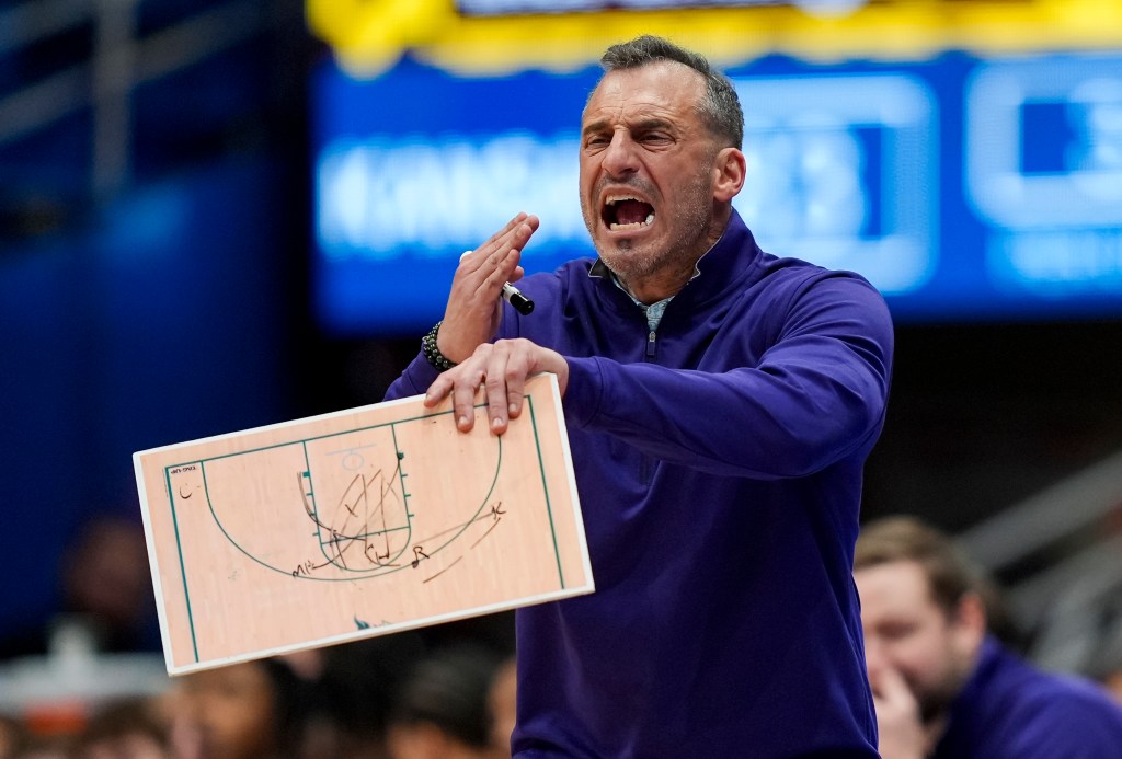 Green Bay coach Will Ryan yelling during the NCAA basketball game against Kansas.