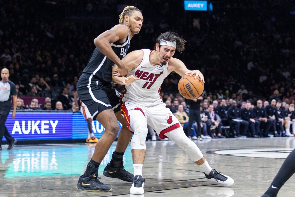 Noah Clowney #21 of the Brooklyn Nets defends against Jaime Jaquez Jr. #11 of the Miami Heat during the second half at Barclays Center, Thursday, Dec. 18, 2025, in Brooklyn, NY. 