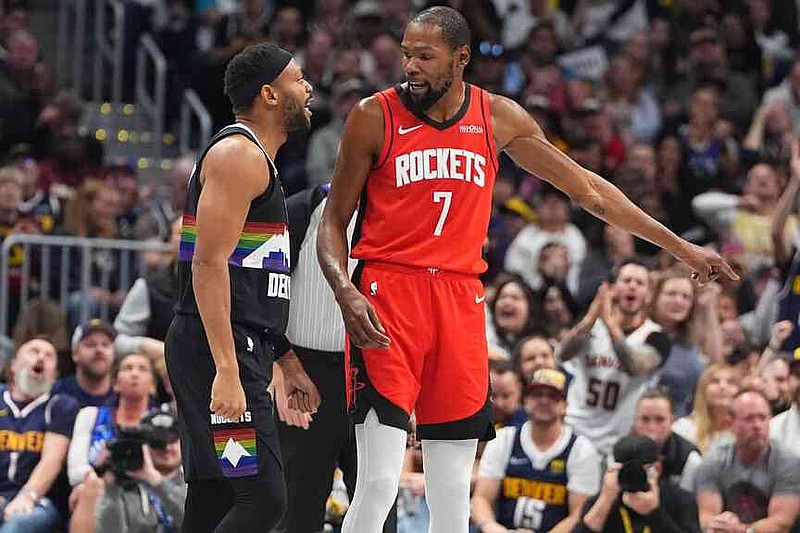 Houston Rockets forward Kevin Durant, right, argues with Denver Nuggets guard Bruce Brown in the second half of an NBA basketball game Saturday, Dec. 20, 2025, in Denver. (AP Photo/David Zalubowski)