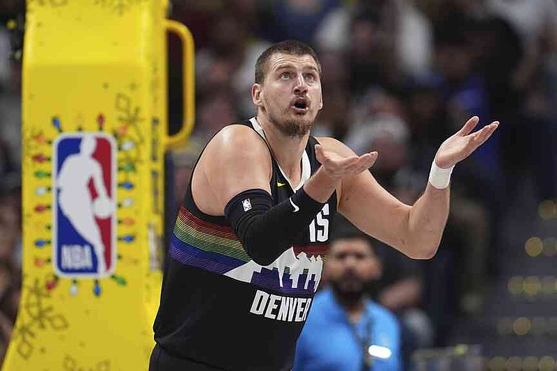 Denver Nuggets center Nikola Jokić reacts after he was called for a foul against the Minnesota Timberwolves in the first half of an NBA basketball game Thursday, Dec. 25, 2025, in Denver. (AP Photo/David Zalubowski)