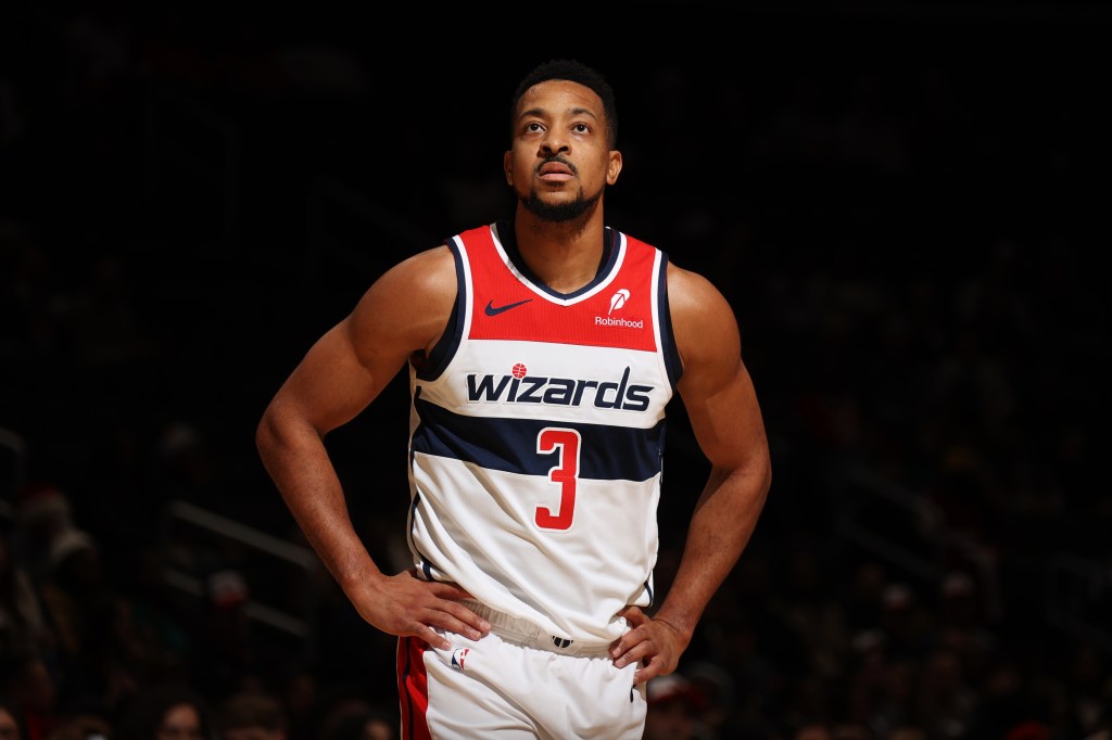 A Washington Wizards player wearing a number 3 jersey, looking up.