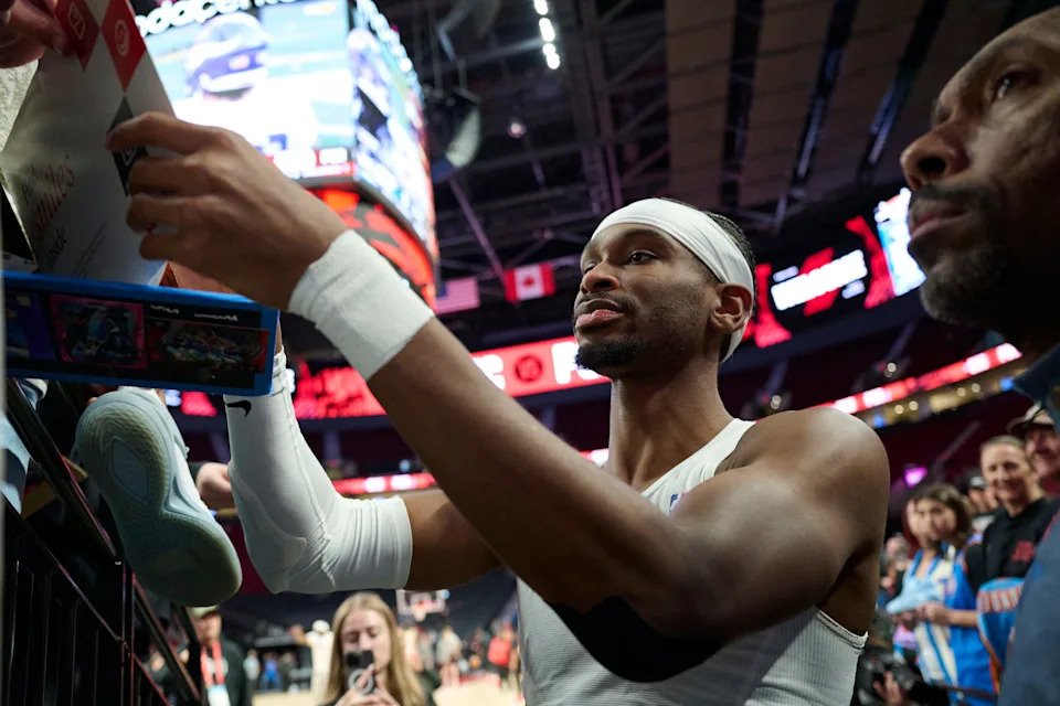 Nov 30, 2025; Portland, Oregon, USA; Oklahoma City Thunder guard Shai Gilgeous-Alexander (2) signs autographs before a game against the Portland Trail Blazers at Moda Center. Mandatory Credit: Troy Wayrynen-Imagn Images