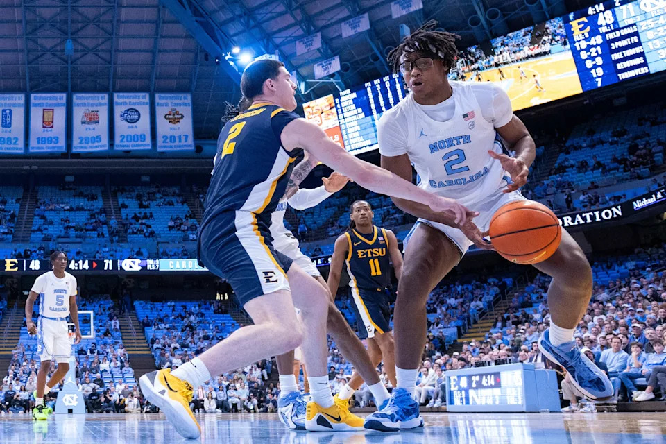 Dec 16, 2025; Chapel Hill, North Carolina, USA; North Carolina Tar Heels forward James Brown (2) gets fouled by ETSU Buccaneers guard Maki Johnson (2) during the second half at Dean E. Smith Center. Mandatory Credit: Scott Kinser-Imagn Images