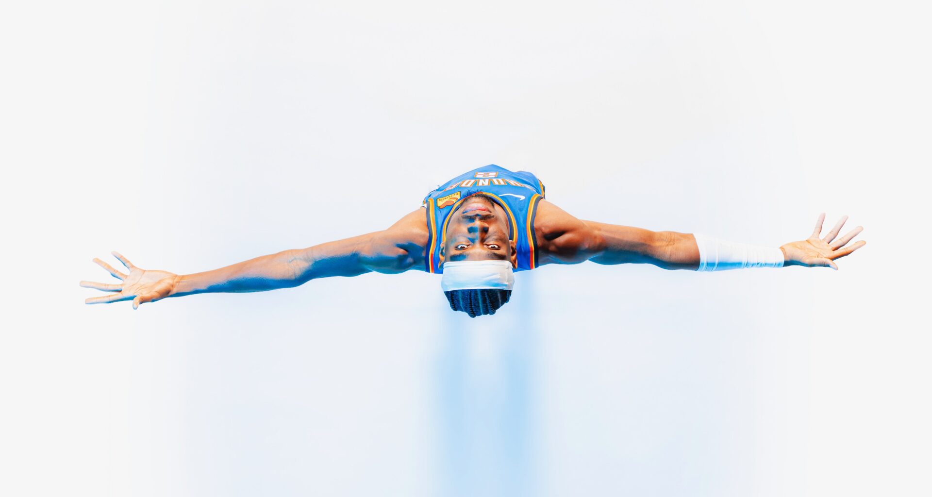 Shai Gilgeous-Alexander posing with his arms outstretched.