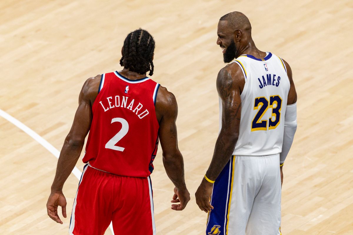 Kawhi Leonard #2 of the LA Clippers and LeBron James #23 of the Los Angeles Lakers talk between plays during an NBA basketball game, Saturday December 20, 2025 in Inglewood, Calif.