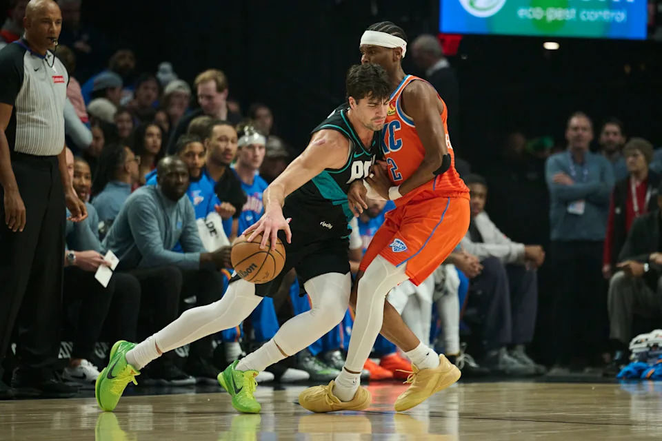 Nov 30, 2025; Portland, Oregon, USA; Portland Trail Blazers forward Deni Avdija (8) drives to the basket during the first half against Oklahoma City Thunder guard Shai Gilgeous-Alexander (2) at Moda Center. Mandatory Credit: Troy Wayrynen-Imagn Images