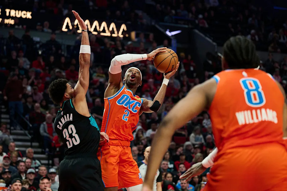 Nov 30, 2025; Portland, Oregon, USA; Oklahoma City Thunder guard Shai Gilgeous-Alexander (2) shoots a basket during the first half against Portland Trail Blazers forward Toumani Camara (33) at Moda Center. Mandatory Credit: Troy Wayrynen-Imagn Images