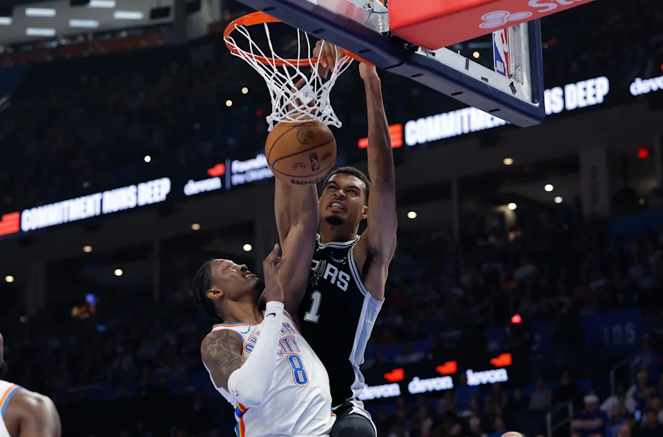 Dec 25, 2025; Oklahoma City, Oklahoma, USA; San Antonio Spurs forward Victor Wembanyama (1) dunks over Oklahoma City Thunder guard Jalen Williams (8) during the second quarter at Paycom Center. Mandatory Credit: Alonzo Adams-Imagn Images