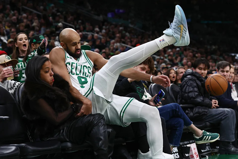 Dec 5, 2025; Boston, Massachusetts, USA; Boston Celtics guard Derrick White (9) falls into the fans after trying to save a loose ball from going out of bounds during the second half against the Los Angeles Lakers at TD Garden. Mandatory Credit: Winslow Townson-Imagn Images