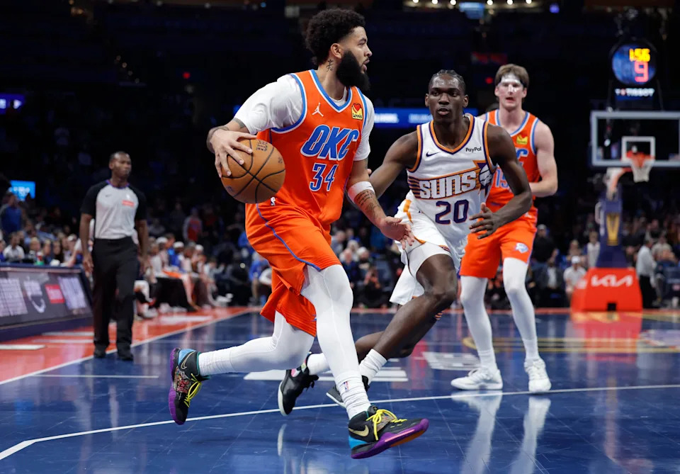 Dec 10, 2025; Oklahoma City, Oklahoma, USA; Oklahoma City Thunder guard Kenrich Williams (34) drives to the basket beside Phoenix Suns forward Rasheer Fleming (20) during the second half at Paycom Center. Mandatory Credit: Alonzo Adams-Imagn Images