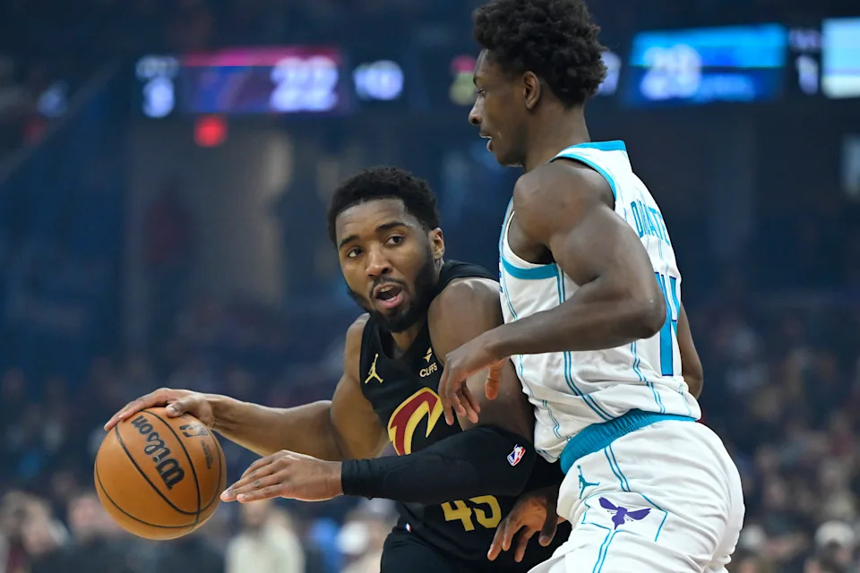 Cleveland Cavaliers guard Donovan Mitchell (45) is defended by Charlotte Hornets forward Moussa Diabate (14) on Dec. 14, 2025, in Cleveland.