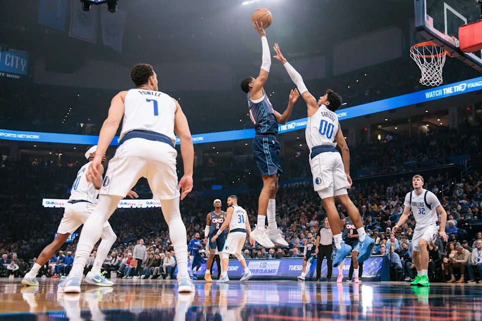 OKLAHOMA CITY, OKLAHOMA - DECEMBER 05: Aaron Wiggins #21 of the Oklahoma City Thunder shoots the ball over Max Christie #00 of the Dallas Mavericks during the first half at Paycom Center on December 5, 2025 in Oklahoma City, Oklahoma. NOTE TO USER: User expressly acknowledges and agrees that, by downloading and or using this photograph, User is consenting to the terms and conditions of the Getty Images License Agreement. (Photo by William Purnell/Getty Images)